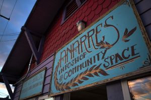 Anarres Infoshop & Community Space sign on a colorful building.