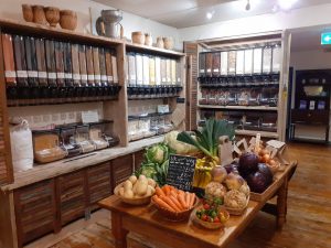 Bulk food dispensers and fresh produce at Reading International Solidarity Centre.