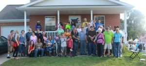 Group photo of Detroit Eviction Defense volunteers in front of a house.
