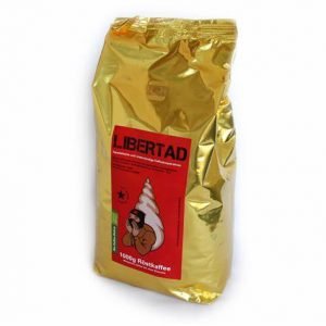 Gold bag of Café Libertad Kollektiv coffee with a red label featuring a cartoon character.