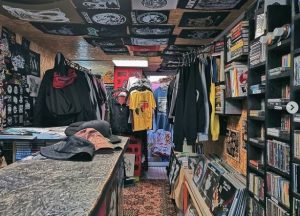 Inside Кирпич: a vintage clothing store featuring records, band tees, and punk rock merchandise.