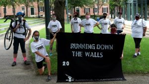 Lowell Lawrence Anarchist Black Cross supporters holding "Running Down the Walls" banner.