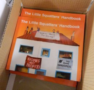 The Little Squatters' Handbook in a box. "Homes Not Profit!" and "We're Here To Stay!" Relevant to Advisory Service For Squatters.