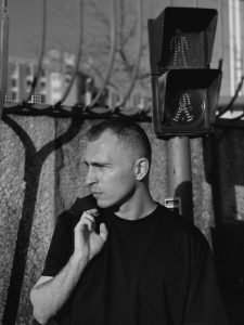 Pensive man in black shirt near crosswalk. How I Became A Traitor.